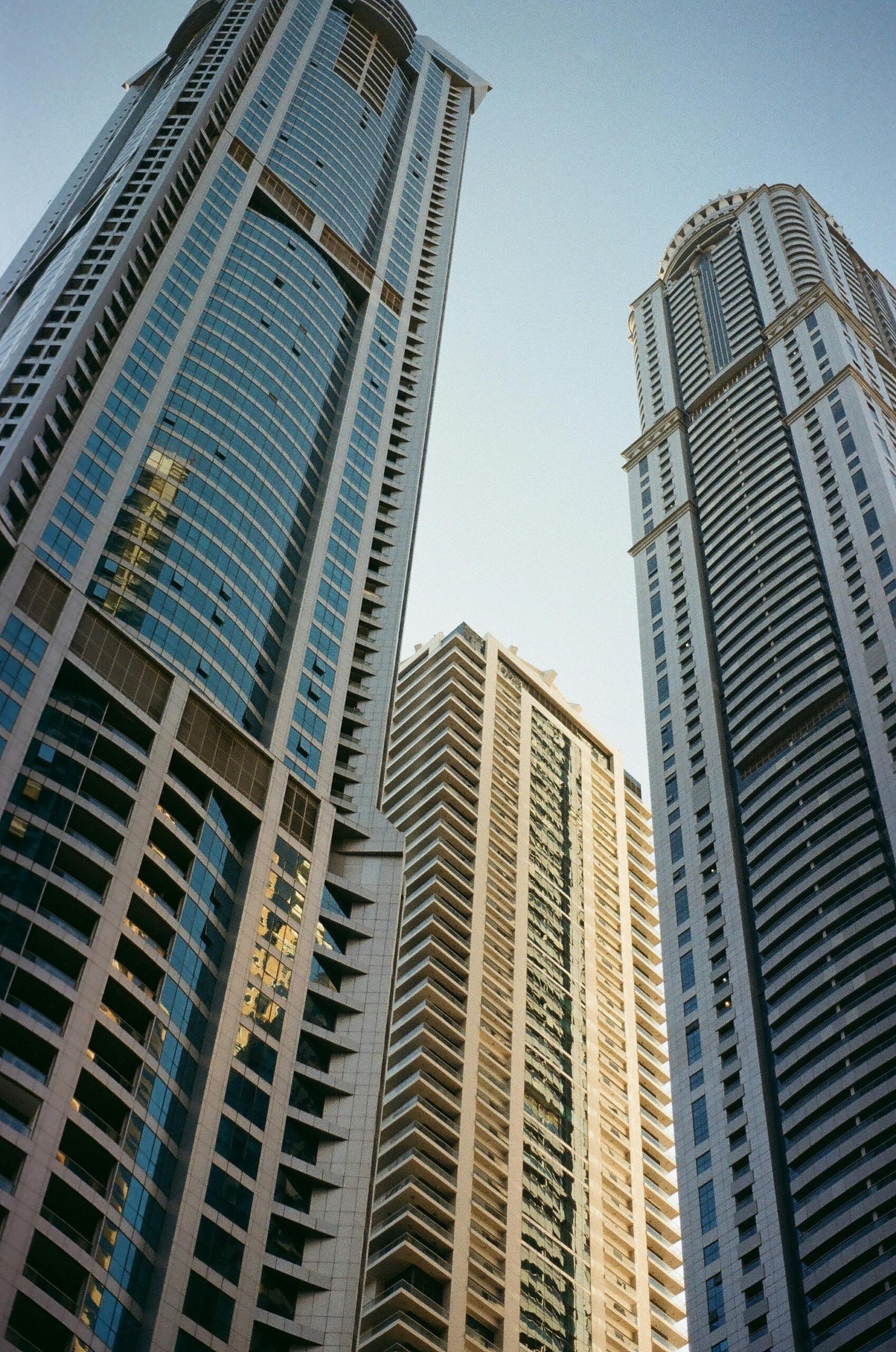 Captivating view of Dubai's towering skyscrapers against a clear sky, showcasing urban grandeur.